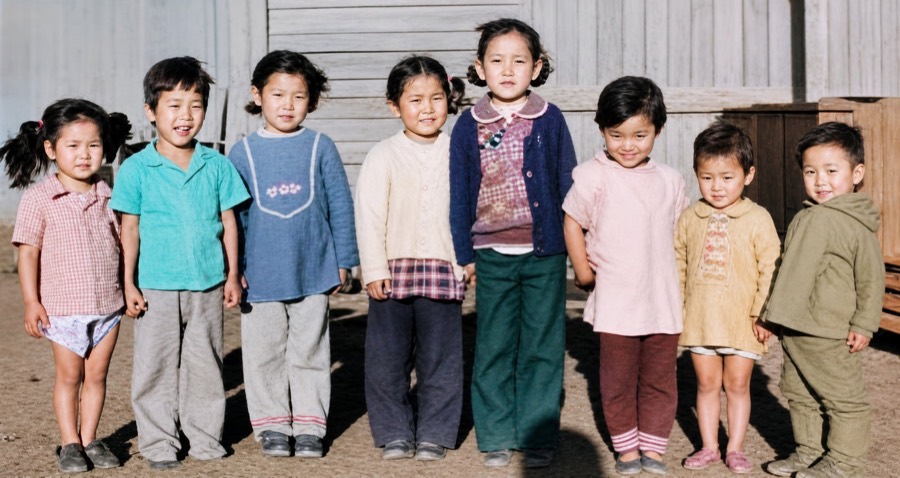 Restored color group photo of eight young children standing in a row
