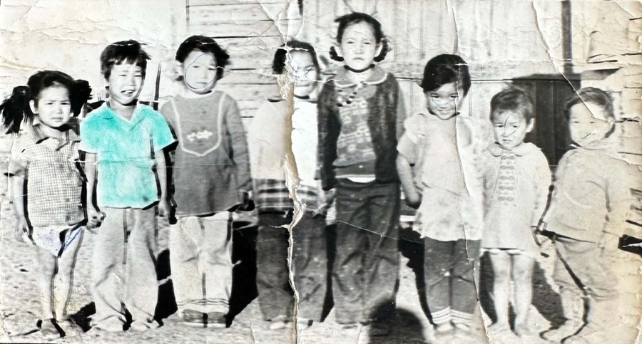 Original faded black-and-white group photo of eight young children