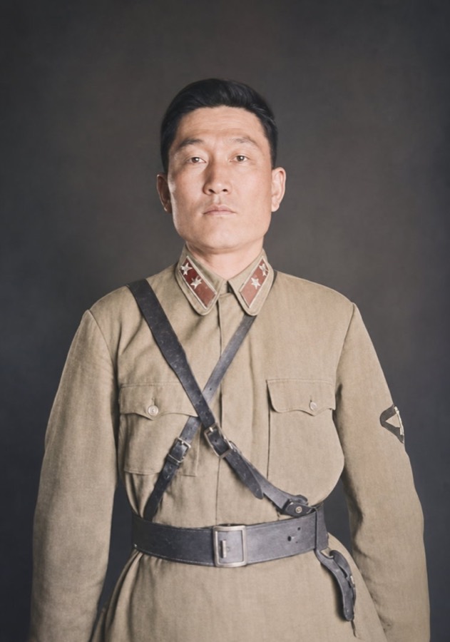 Colorized portrait of a man in a khaki uniform with a leather strap