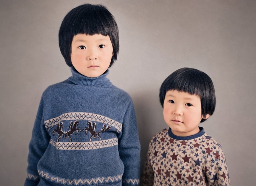 Colorized photo of two young sisters in blue and patterned knit sweaters