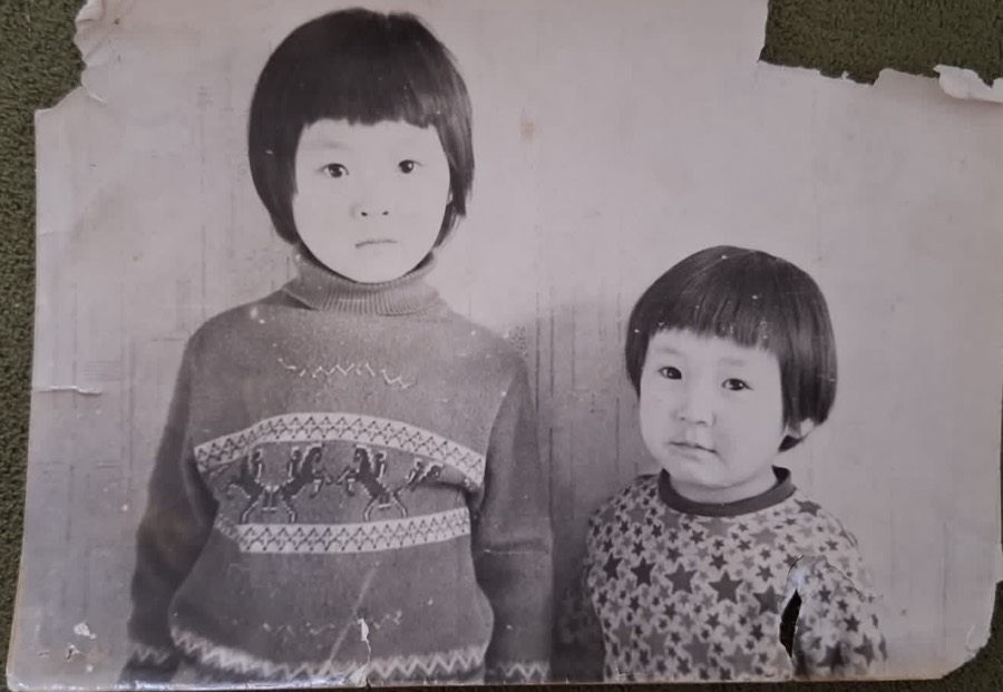 Original black-and-white photo of two young sisters